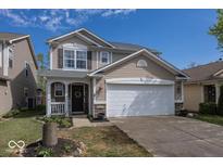 Charming two-story home with a two-car garage, landscaped yard, and inviting front porch with stone accents at 10208 Clear Sky Dr, Avon, IN 46123