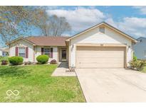 Charming one-story home with well-maintained lawn, fresh landscaping, and a two car garage at 105 Fountain Dr, Mooresville, IN 46158