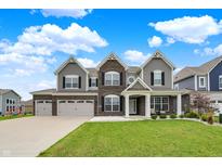Beautiful two-story home with brick and siding, three-car garage, and well-manicured lawn at 10811 Wild Orchard Ln, Indianapolis, IN 46239