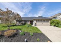 Charming single-story home with well-manicured lawn, black mulch, and attached two-car garage at 10844 Bentwater Ln, Fishers, IN 46037