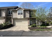 Charming two-story home with attached garage, landscaped yard, and welcoming front door at 11223 Fonthill Dr, Indianapolis, IN 46236