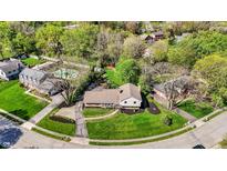 Aerial view showcases the home's prime location in a serene neighborhood with mature trees and well-kept lawns at 11626 Forest Dr, Carmel, IN 46033