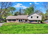 Charming two-story home with landscaped yard, blue shutters, and a well-manicured lawn at 11626 Forest Dr, Carmel, IN 46033