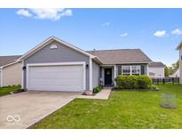 Charming single-story home featuring a well-maintained lawn and an attached two-car garage at 123 Thistlewood Dr, Greenfield, IN 46140