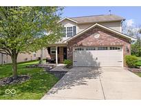 Charming home with a brick front, attached two-car garage and mature tree in the front yard at 132 Thistlewood Dr, Greenfield, IN 46140