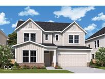 Charming two-story home features a two-car garage, brick accents, and manicured lawn at 14215 Coyote Ridge Dr, Noblesville, IN 46060