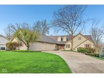 Spacious home with a well-manicured lawn, large driveway, and charming architectural details at 168 Yorkshire W Blvd, Cumberland, IN 46229
