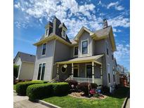 Charming two-story home with beautiful front yard landscaping and inviting front porch at 23 N West St, Shelbyville, IN 46176