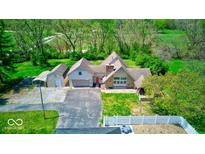 A beautiful aerial view showing the layout of the home, detached garage, and surrounding greenery at 260 17Th St, Columbus, IN 47201