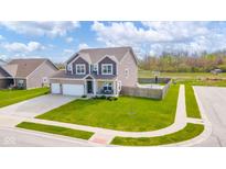 Beautiful two-story home with a two car garage, spacious yard and an in-ground trampoline and basketball court at 403 N Crystal Dr, Fortville, IN 46040