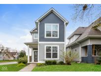 Charming two-story home featuring attractive gray siding, well-maintained landscaping, and a welcoming front entrance at 4077 Rookwood Ave, Indianapolis, IN 46208