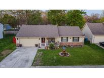 Charming single-story home with a well-maintained lawn and attached garage at 4411 Rotterdam Dr, Indianapolis, IN 46228