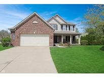 Charming two-story home with a brick facade, attached garage, and a well-manicured lawn, perfect for suburban living at 5702 Saratoga Pl, Plainfield, IN 46168