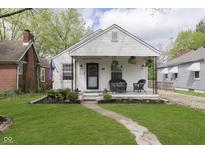 Charming single-story home featuring a cozy front porch and well-manicured lawn at 6180 Crittenden Ave, Indianapolis, IN 46220