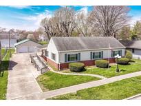 Charming single-story home boasts a well-manicured lawn, brick accents, and a convenient wheelchair ramp at 830 N 16Th St, Elwood, IN 46036