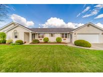 Charming one-story home with a manicured lawn and beautiful landscaping, showcasing curb appeal at 838 Deerfield Rd, Anderson, IN 46012
