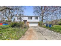 Charming two-story home featuring a white facade, attached garage and a well-maintained front yard at 9836 Malvina Ct, Indianapolis, IN 46229