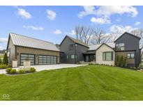 Stunning exterior elevation of this modern home with well manicured yard and three-car garage at 1333 Chatham Rdg Ct, Westfield, IN 46074