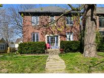 Charming brick home with manicured landscaping and a welcoming entryway, perfect for a cozy and inviting atmosphere at 1404 Broadway St # Apt G, Indianapolis, IN 46202