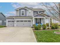 Beautiful two-story home with a three-car garage and well-manicured lawn and landscaping at 16080 Cabin Hill Dr, Noblesville, IN 46060