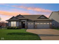 Charming one-story home with a well-manicured lawn, attached two-car garage, and neutral color scheme at 1973 Mobley Dr, Westfield, IN 46074