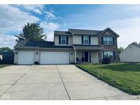 Charming two-story home with a well-manicured lawn and a spacious three-car garage at 326 Virginia St, Fortville, IN 46040
