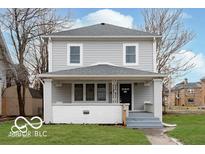 Charming two-story home with a covered front porch and freshly painted siding at 3758 Broadway St, Indianapolis, IN 46205