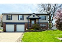 Charming two-story home with a well-maintained lawn, two-car garage and nice landscaping at 436 Tavistock Dr, Mooresville, IN 46158