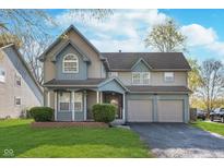 Charming two-story home with a well-manicured lawn and a two-car garage at 4917 Melbourne Rd, Indianapolis, IN 46228