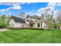 Charming two-story home with a well-manicured lawn and beautiful landscaping at 5212 Knollton Rd, Indianapolis, IN 46228