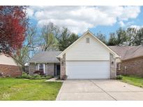 Charming brick and siding home with a two-car garage, manicured lawn and tasteful landscaping at 6853 Arjay Dr, Indianapolis, IN 46217