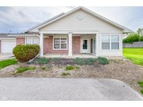 Charming single-story home featuring a brick facade, covered porch, and well-maintained landscaping at 10822 Cape Coral Ln, Indianapolis, IN 46229