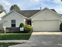 Charming single-story home with a two-car garage and well-maintained front yard at 11875 Buck Creek Cir, Noblesville, IN 46060