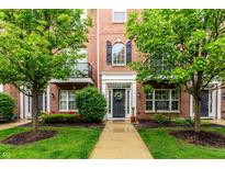 Charming brick townhome featuring a landscaped front yard and inviting entryway at 11905 Kelso Dr # 3, Zionsville, IN 46077