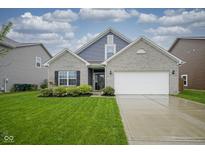 Charming home features a well-manicured lawn and attached two car garage at 1299 W Crystal Dr, Fortville, IN 46040