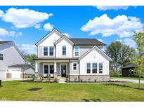Charming two-story home featuring a well-manicured lawn, stone accents, and a welcoming front porch at 14349 Marsdale Pl, Carmel, IN 46074
