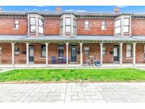 Attractive brick townhouse with covered porch and well-kept lawn at 1476 N Illinois St, Indianapolis, IN 46202