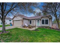 Charming home featuring a well-maintained lawn, attached garage, and inviting front entrance at 1910 Riverstone Ct, Westfield, IN 46074