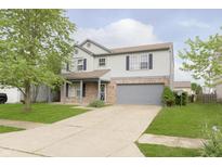 Two-story home with light gray siding, brick accents, and a two-car garage at 2348 Shadowbrook Dr, Plainfield, IN 46168
