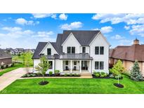 Stunning two-story white home with black trim, lush lawn, and inviting front porch at 284 Chatham Hills Blvd, Westfield, IN 46074