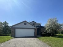 Charming home with a well-manicured lawn, a two-car garage, and attractive brick and siding accents at 2904 Inverrary Ct, Indianapolis, IN 46234