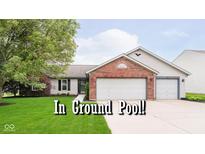 Charming single-story home boasts a brick facade, two-car garage, and well-manicured lawn at 324 Palmyra Dr, Indianapolis, IN 46239