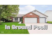 Charming single Gathering home with a well-manicured lawn and in-ground pool text overlay at 324 Palmyra Dr, Indianapolis, IN 46239