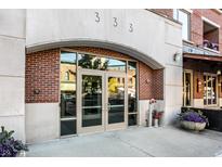 Stylish building entrance featuring double glass doors, brick accents, and modern architectural details at 333 Massachusetts Ave # 204, Indianapolis, IN 46204