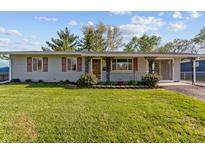 Charming single-story home featuring a well-maintained lawn and inviting front porch at 3561 Winings Ave, Indianapolis, IN 46221