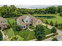Beautiful two-story home with manicured lawn and landscaping, set on a corner lot with mature trees at 4707 Branch View Way, Indianapolis, IN 46234