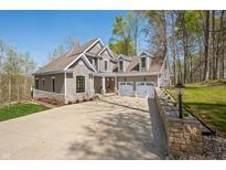 Beautiful two-story home featuring a large driveway, a two car garage and a manicured front yard at 4955 N 500 W, Columbus, IN 47201