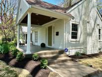 Charming exterior view of home featuring a covered front entrance with white columns and well-manicured landscaping at 5135 N Kenwood Ave, Indianapolis, IN 46208