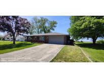 Charming brick home with a well-maintained lawn and a cozy front porch at 5444 S Holiday Dr, Columbus, IN 47203