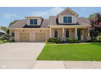 Charming brick two-story home with a two-car garage and well-manicured front lawn at 6345 Canak Dr, Avon, IN 46123